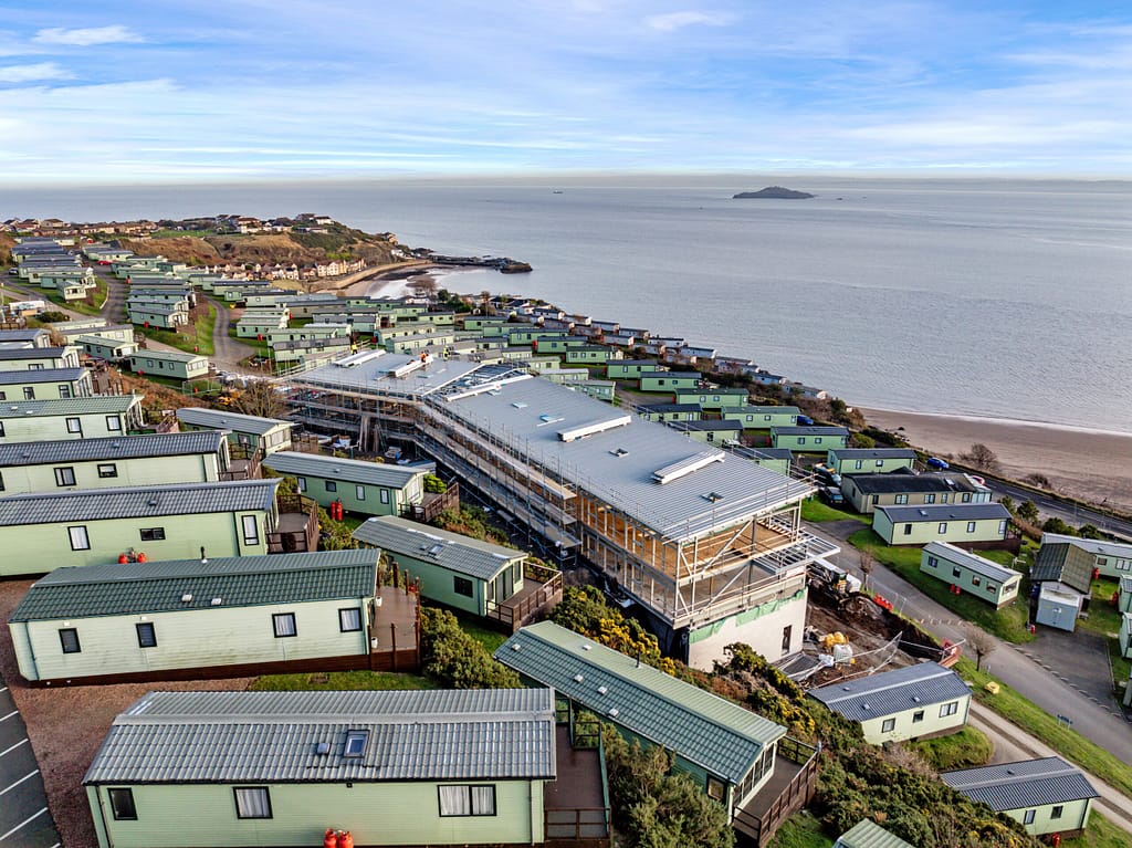 Aerial view of Pettycur Bay Caravan Park in Kinghorn with coastal holiday homes overlooking the Firth of Forth.